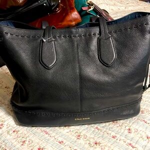 Cole Haan black 100% genuine Leather tote.  Very soft and light. Beautiful bag.